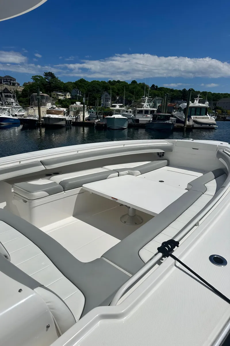 Slide: The Image of 2022 Regulator 34 boat docked in a marina under a clear blue sky. - 9