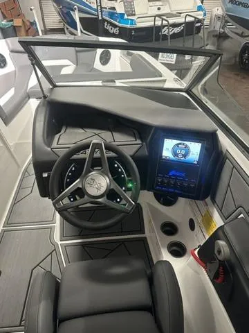 Slide: The Image of 2023 ATX Surf Boats 24 Type-S dashboard and steering wheel with touchscreen display. - 12