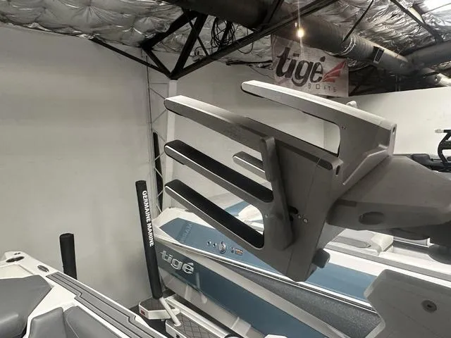 Slide: The Image of 2023 ATX Surf Boats 24 Type-S in showroom with Tige Boats banner. - 8