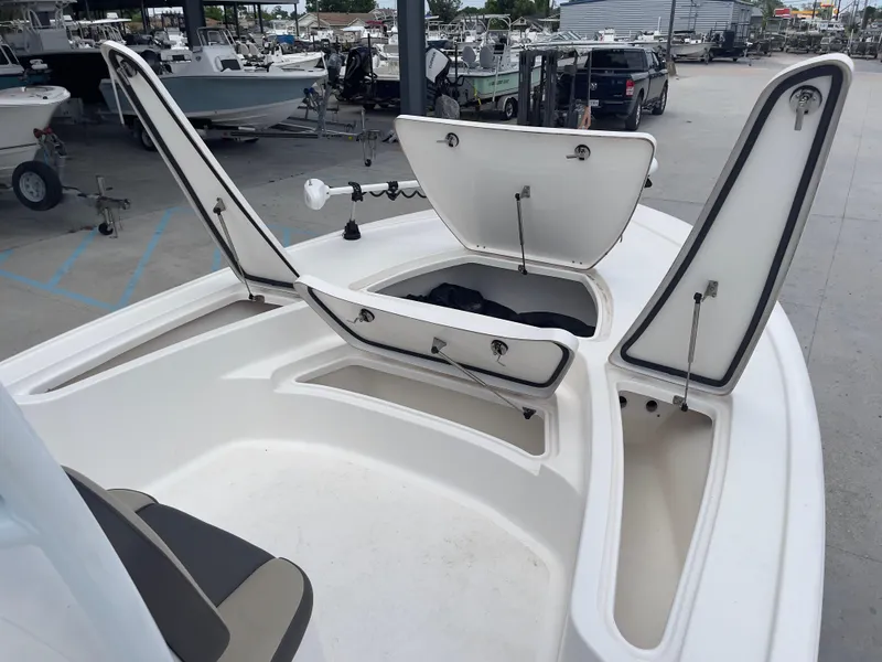 Slide: The Image of 2019 Tidewater 2410 Bay Max boat with open storage compartments. - 11