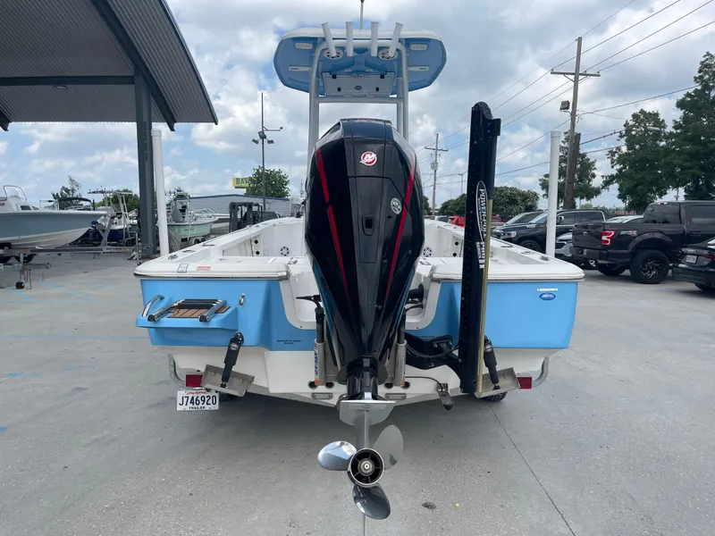 Slide: The Image of 2019 Tidewater 2410 Bay Max boat, rear view with outboard motor and blue hull. - 2