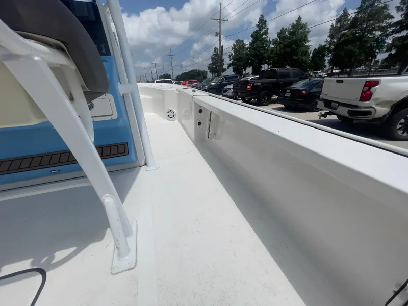 Slide: The Image of 2019 Tidewater 2410 Bay Max boat interior with white deck and blue accents. - 25
