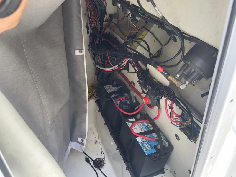Slide: The Image of 2019 Tidewater 2410 Bay Max boat battery compartment with wiring. - 30
