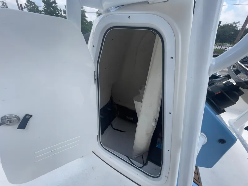 Slide: The Image of 2019 Tidewater 2410 Bay Max boat storage compartment with open door. - 32