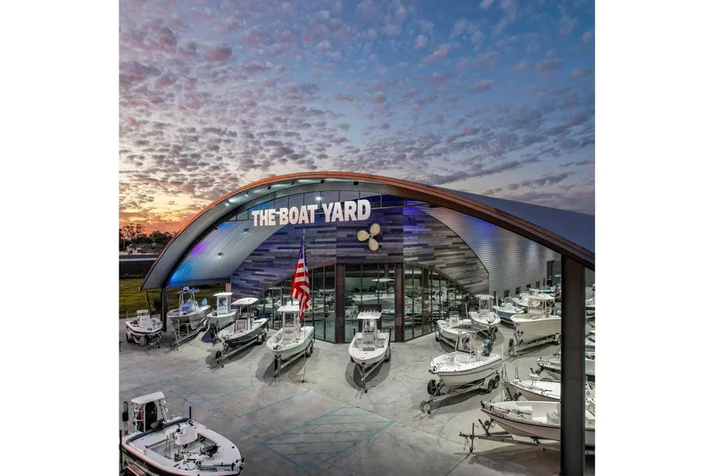 Slide: The Image of The Boat Yard showcasing 2019 Tidewater 2410 Bay Max boats at sunset. - 41