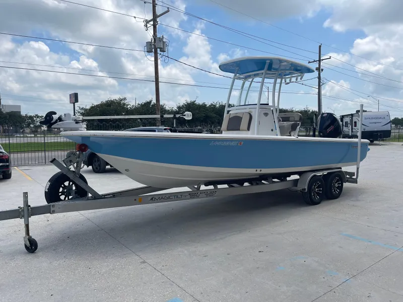 Slide: The Image of 2019 Tidewater 2410 Bay Max boat on a trailer under a partly cloudy sky. - 6