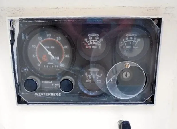 Slide: The Image of Control panel of a 1961 Rhodes Swiftsure boat with gauges and key slot. - 15