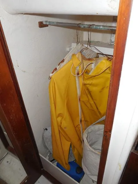 Slide: The Image of Yellow raincoat hanging in a 1961 Rhodes Swiftsure closet. - 19