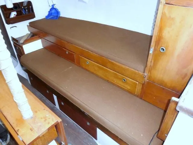 Slide: The Image of Interior of 1961 Rhodes Swiftsure boat with wooden storage and brown cushions. - 20
