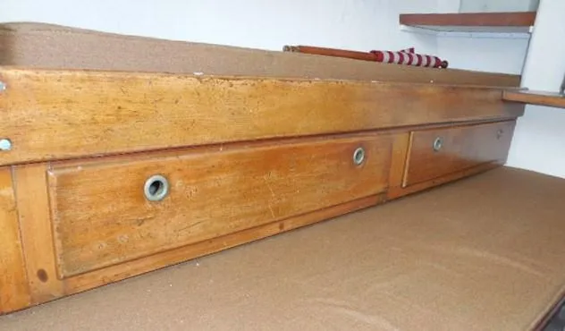 Slide: The Image of Wooden interior of 1961 Rhodes Swiftsure boat with storage drawers and shelf. - 29