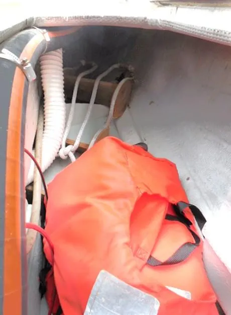 Slide: The Image of Interior of a 1961 Rhodes Swiftsure sailboat with a red life jacket. - 38