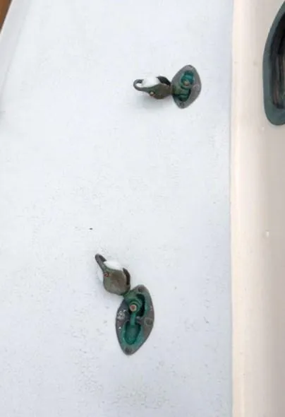 Slide: The Image of Vintage Rhodes Swiftsure 1961 boat hardware on white surface. - 46