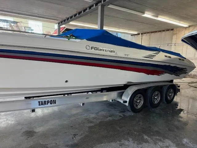 Slide: The Image of 2004 Fountain 35 Executioner speedboat on a Tarpon trailer in a storage facility. - 1