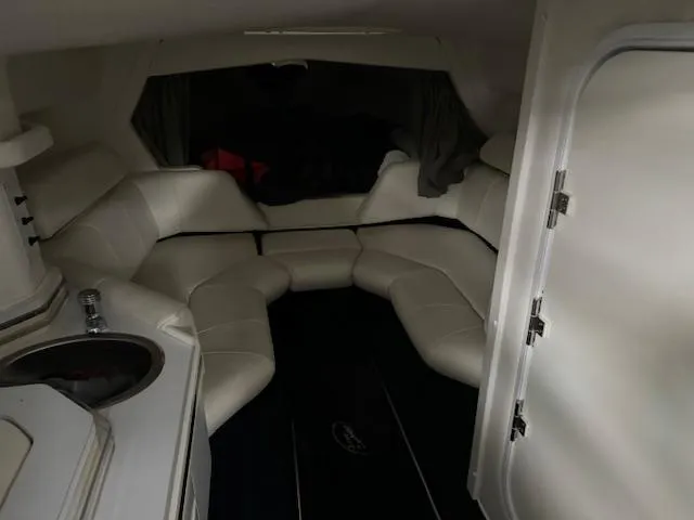 Slide: The Image of 2004 Fountain 35 Executioner boat interior with white leather seating and kitchenette. - 15