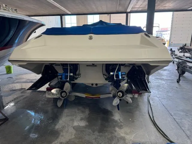 Slide: The Image of 2004 Fountain 35 Executioner speedboat in a garage, rear view showing dual propellers. - 2