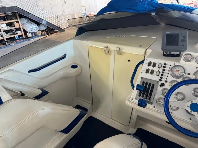 Slide: The Image of 2004 Fountain 35 Executioner boat interior with white and blue accents, control panel, and seating. - 20
