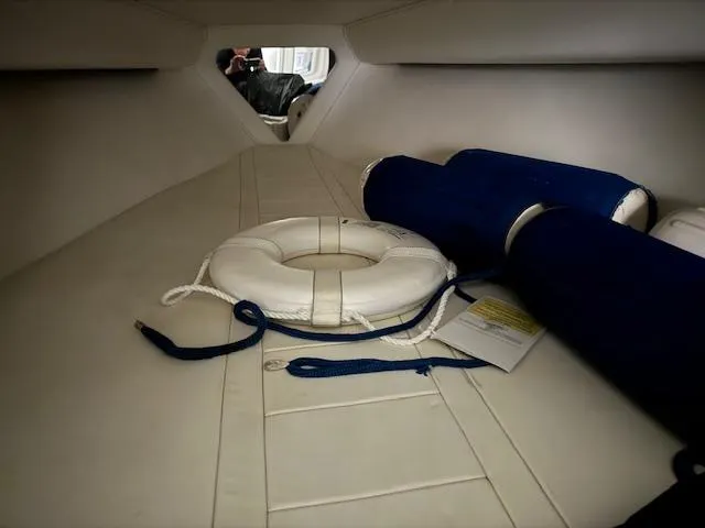 Slide: The Image of Interior of 2004 Fountain 35 Executioner boat with life ring and blue cushions. - 25