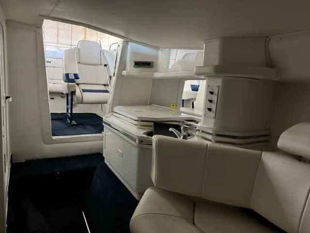 Slide: The Image of Interior of 2004 Fountain 35 Executioner boat with white seating and compact cabin layout. - 27
