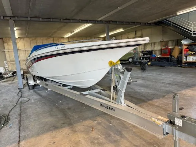 Slide: The Image of 2004 Fountain 35 Executioner boat on a trailer in a garage. - 4