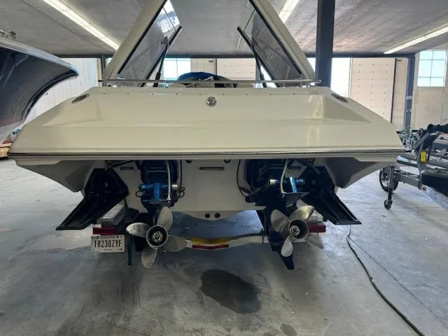 Slide: The Image of 2004 Fountain 35 Executioner boat in a garage, rear view showing dual propellers. - 8