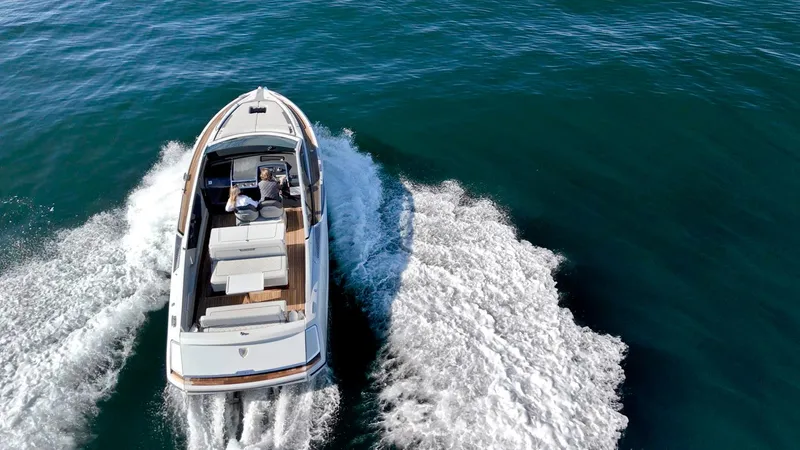 Slide: The Image of 2021 Fairline Fline 33 yacht cruising on open water, aerial view. - 10