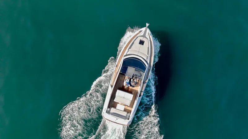 Slide: The Image of Aerial view of 2021 Fairline Fline 33 yacht cruising on clear blue water. - 11