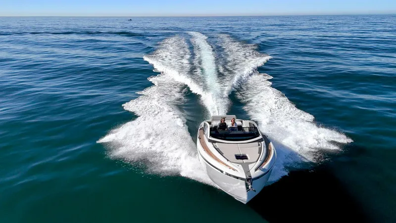 Slide: The Image of 2021 Fairline Fline 33 cruising on open water, leaving a wake behind. - 13