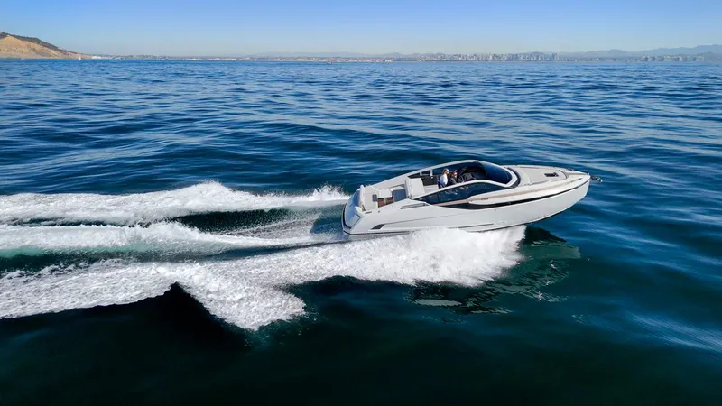 Slide: The Image of 2021 Fairline Fline 33 cruising on open water, creating a dynamic wake. - 15