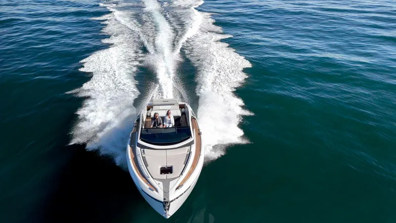 Slide: The Image of 2021 Fairline Fline 33 yacht cruising on open water. - 16