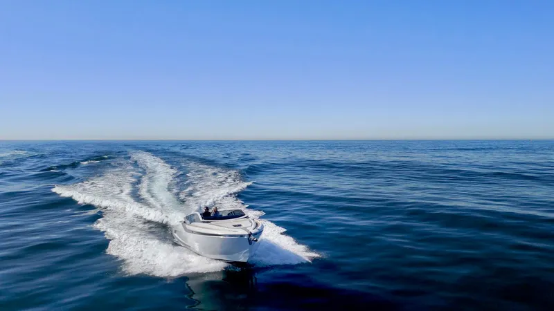 Slide: The Image of 2021 Fairline Fline 33 cruising on open sea under clear blue sky. - 17