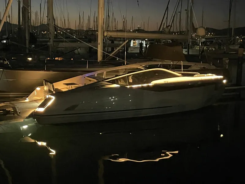 Slide: The Image of 2021 Fairline Fline 33 yacht illuminated at night in a marina. - 19