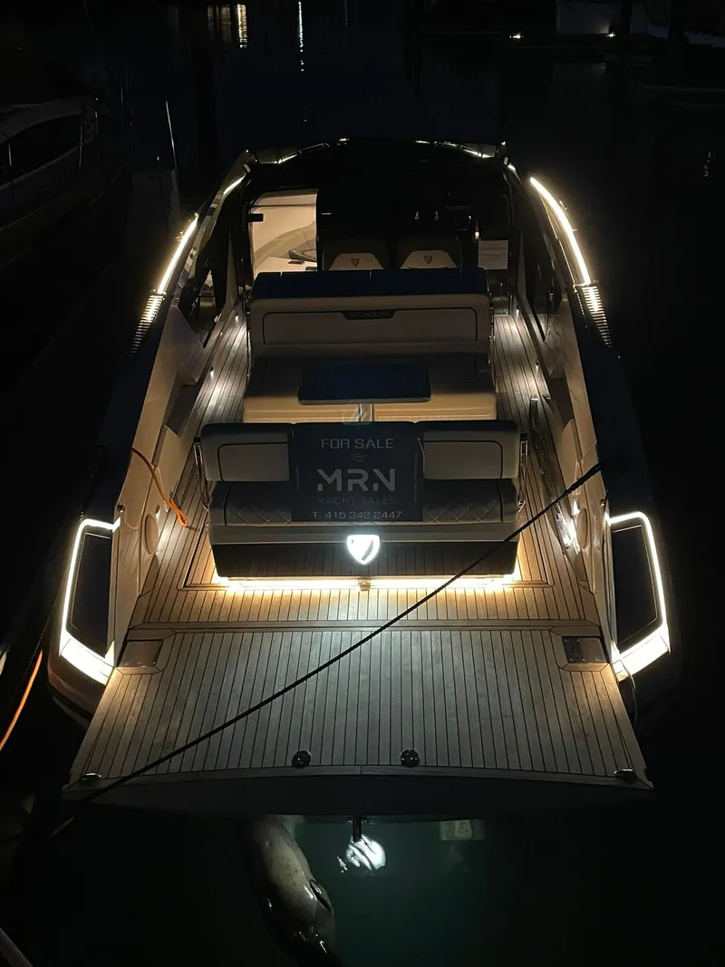 Slide: The Image of 2021 Fairline Fline 33 luxury yacht illuminated at night, rear view. - 20