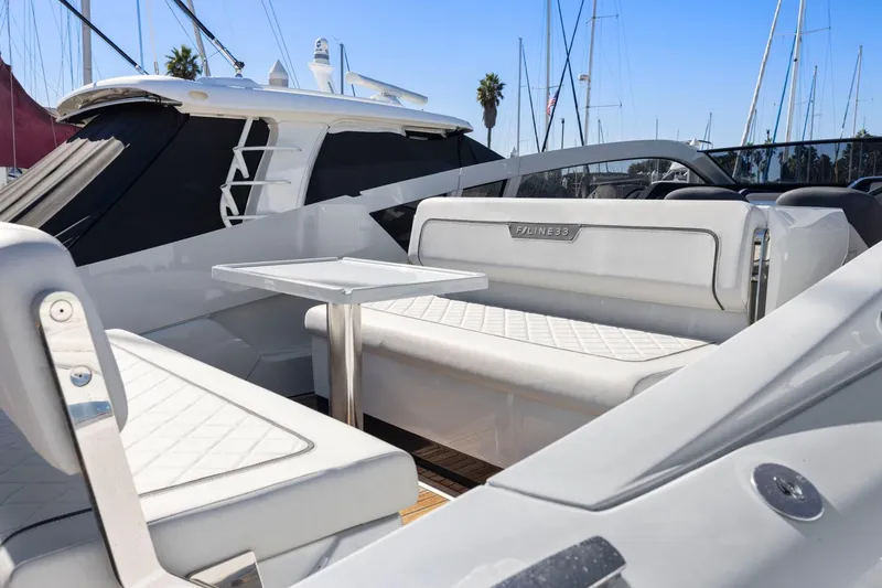 Slide: The Image of 2021 Fairline Fline 33 yacht interior with white seating and table. - 24