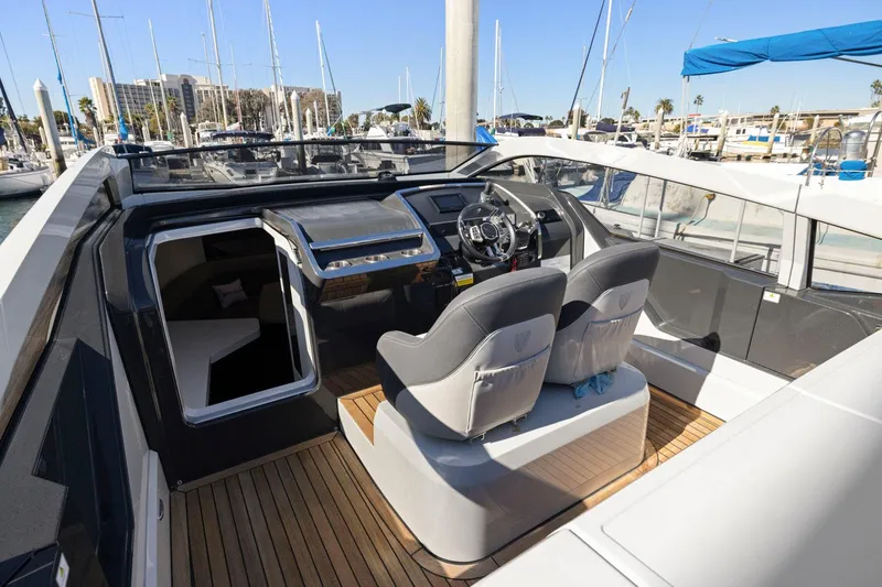 Slide: The Image of 2021 Fairline Fline 33 yacht cockpit with modern helm and seating. - 33