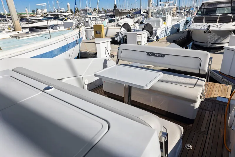 Slide: The Image of 2021 Fairline Fline 33 yacht interior with seating and table at marina. - 34