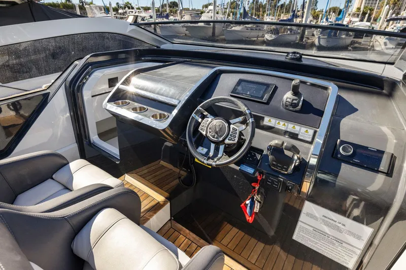 Slide: The Image of 2021 Fairline Fline 33 yacht cockpit with modern controls and luxurious seating. - 36