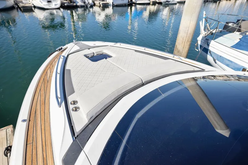 Slide: The Image of Fairline Fline 33 yacht bow, 2021 model, docked in marina with sleek design. - 39