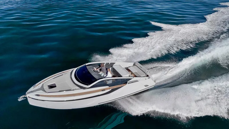 Slide: The Image of 2021 Fairline Fline 33 yacht cruising on open water. - 4