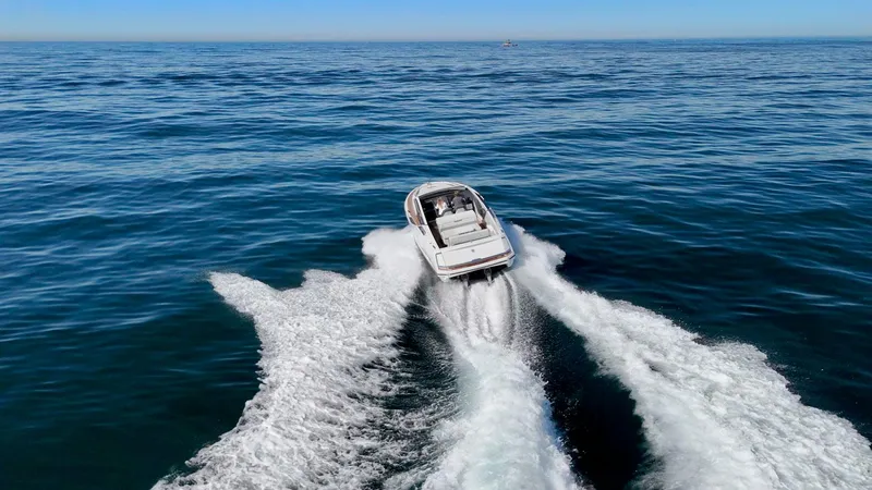 Slide: The Image of Fairline Fline 33 (2021) cruising on open sea, leaving a wake behind. - 7