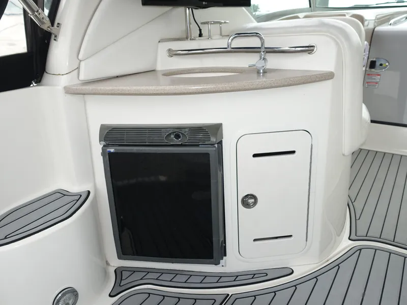Slide: The Image of 2005 Sea Ray 320 Sundancer boat interior with kitchenette and sink. - 11