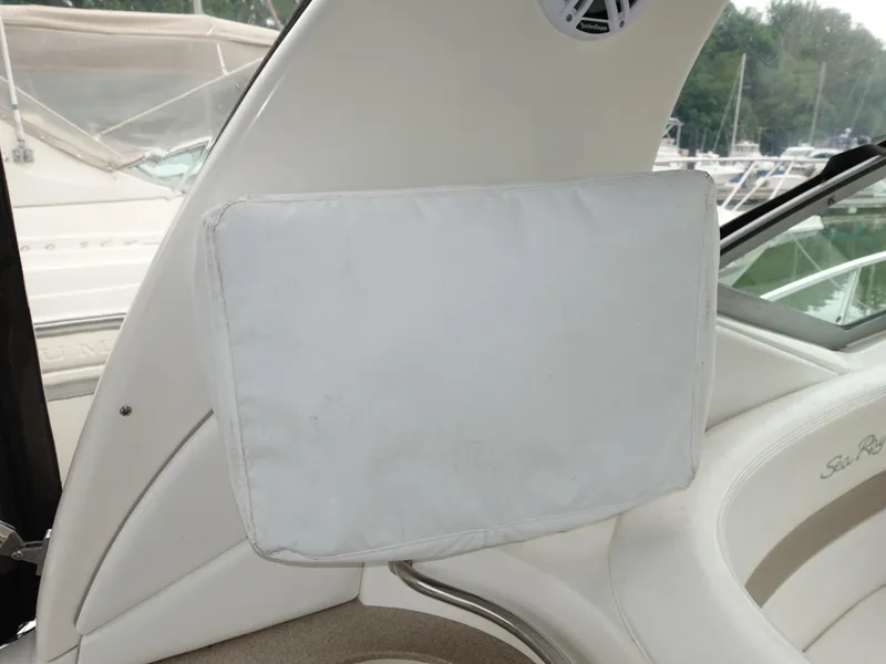 Slide: The Image of 2005 Sea Ray 320 Sundancer interior detail with white cushion and speaker. - 13