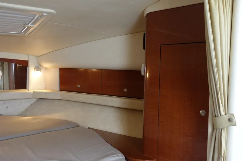 Slide: The Image of Interior cabin of 2005 Sea Ray 320 Sundancer with wood cabinetry and bed. - 18