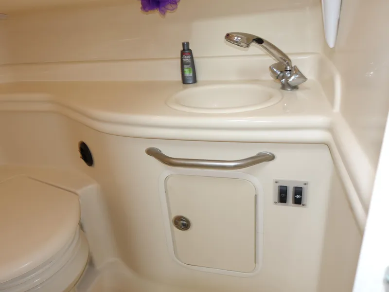 Slide: The Image of 2005 Sea Ray 320 Sundancer bathroom with sink, faucet, and storage cabinet. - 21