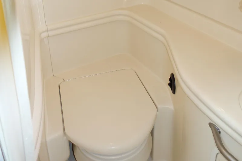 Slide: The Image of 2005 Sea Ray 320 Sundancer boat bathroom with compact toilet. - 22