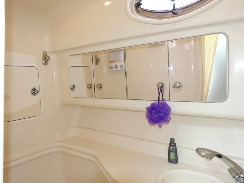 Slide: The Image of Bathroom interior of 2005 Sea Ray 320 Sundancer yacht with mirror and sink. - 23