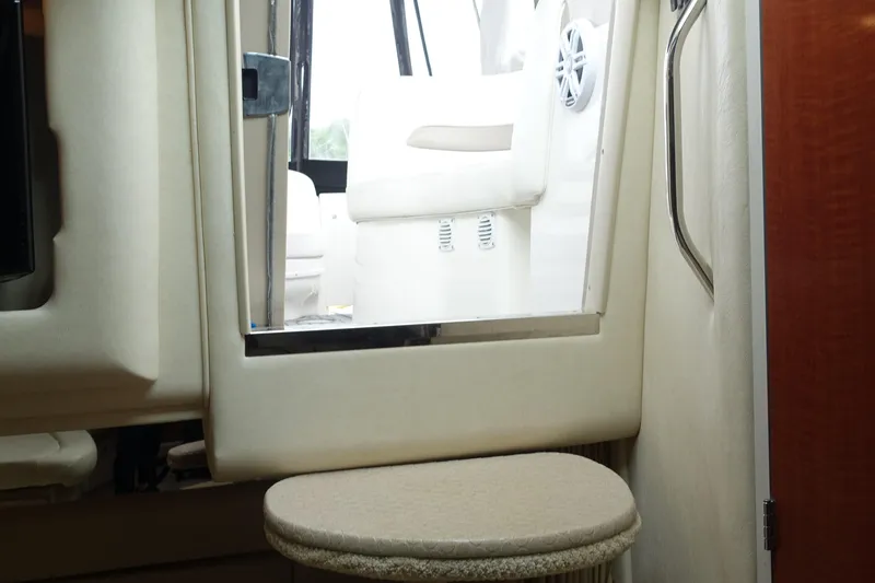 Slide: The Image of Interior view of 2005 Sea Ray 320 Sundancer boat, featuring seating and cabin entrance. - 24