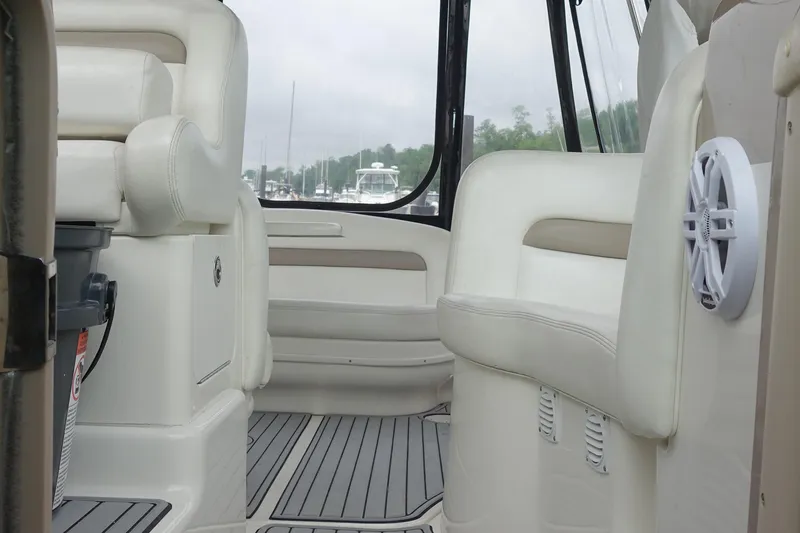 Slide: The Image of Interior of 2005 Sea Ray 320 Sundancer boat with beige seating and wood flooring. - 25
