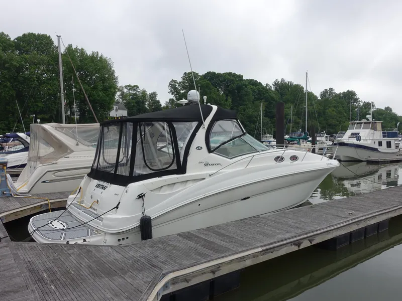 Slide: The Image of 2005 Sea Ray 320 Sundancer docked at marina, surrounded by other boats. - 26