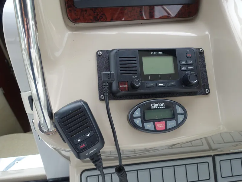Slide: The Image of Garmin radio and Clarion control panel on 2005 Sea Ray 320 Sundancer boat. - 5