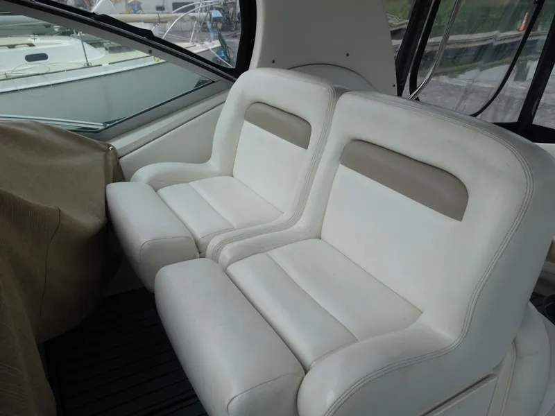 Slide: The Image of 2005 Sea Ray 320 Sundancer interior seating, white leather upholstery, elegant design. - 8